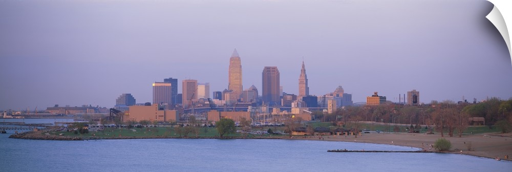 The skyline in Cleveland is shot with a wide angle lens from across a body of water.