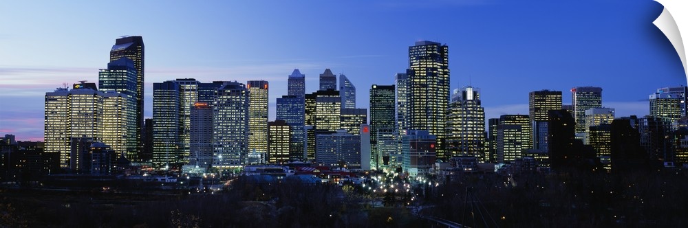 Buildings in a city lit up at dusk, Calgary, Alberta, Canada