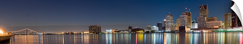 Buildings in a city lit up at dusk, Detroit River, Detroit, Michigan,