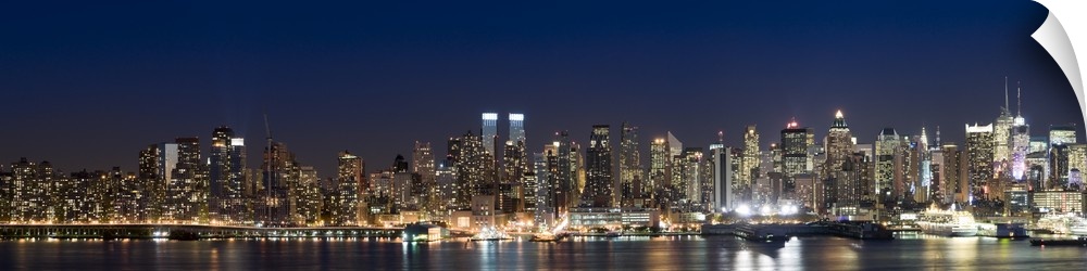 This wall art is a panoramic photograph of the marvelous city skyline illuminated at night.