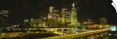 Buildings in a city lit up at night, Gardiner Expressway, Toronto, Ontario, Canada