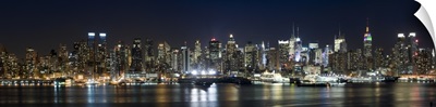 Buildings in a city lit up at night, Hudson River, Manhattan, New York City, New York State,