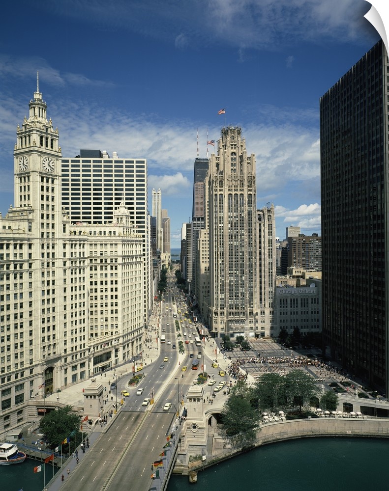 A large vertical piece of a bridge and street running through tall buildings in the city of Chicago.