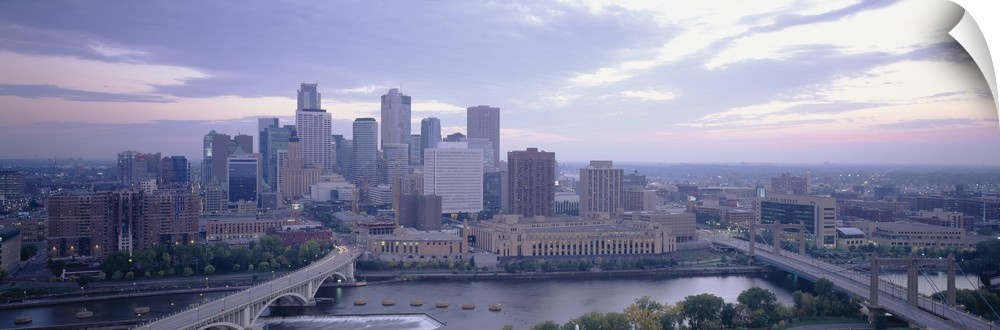 Large panoramic picture of downtown Minneapolis sitting on the banks of the Mississippi River.