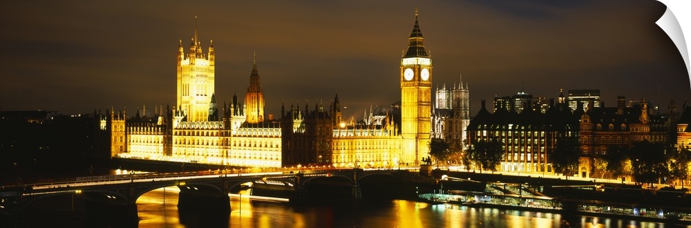 This panoramic piece shows the Big Ben clock tower and the House of Parliament illuminated under a dark night sky.