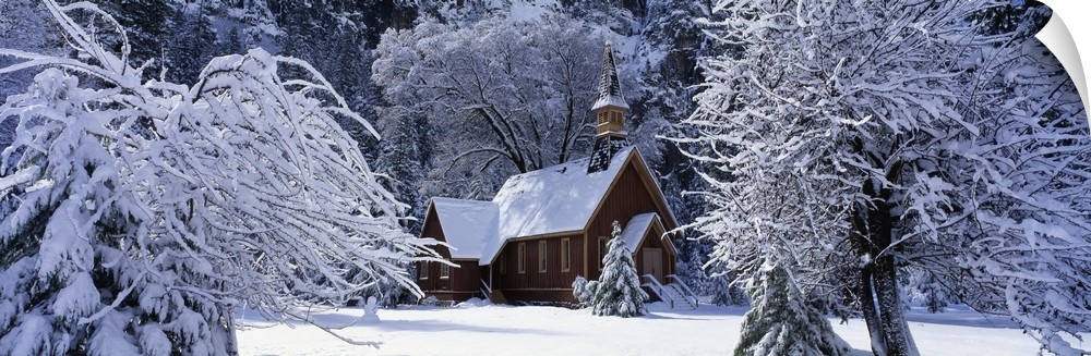Panoramic photo of a church in winter covered in snow at Yosemite National Park in California.