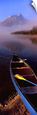 Canoe in lake in front of mountains, Leigh Lake, Rockchuck Peak, Teton Range, Grand Teton National Park, Wyoming