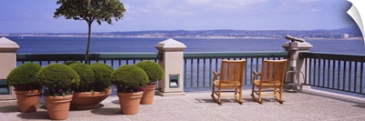 Chairs and potted plants on a deck, Monterey Bay, California