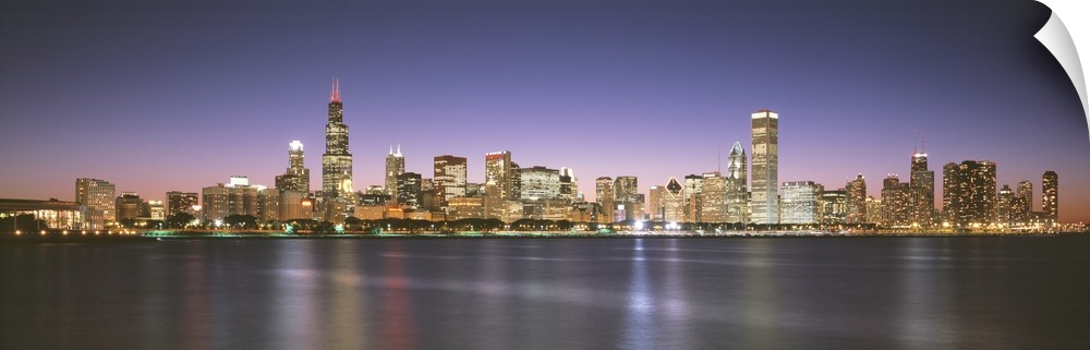 Panoramic photograph composed of the busy skyline of this landmark city in Illinois.  The blurred reflections of the brigh...