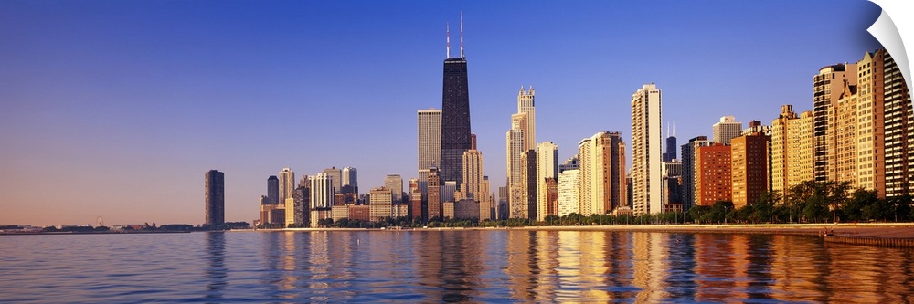 Large panoramic view taken from the water of the Chicago skyline with the sears tower highlighted in the middle.