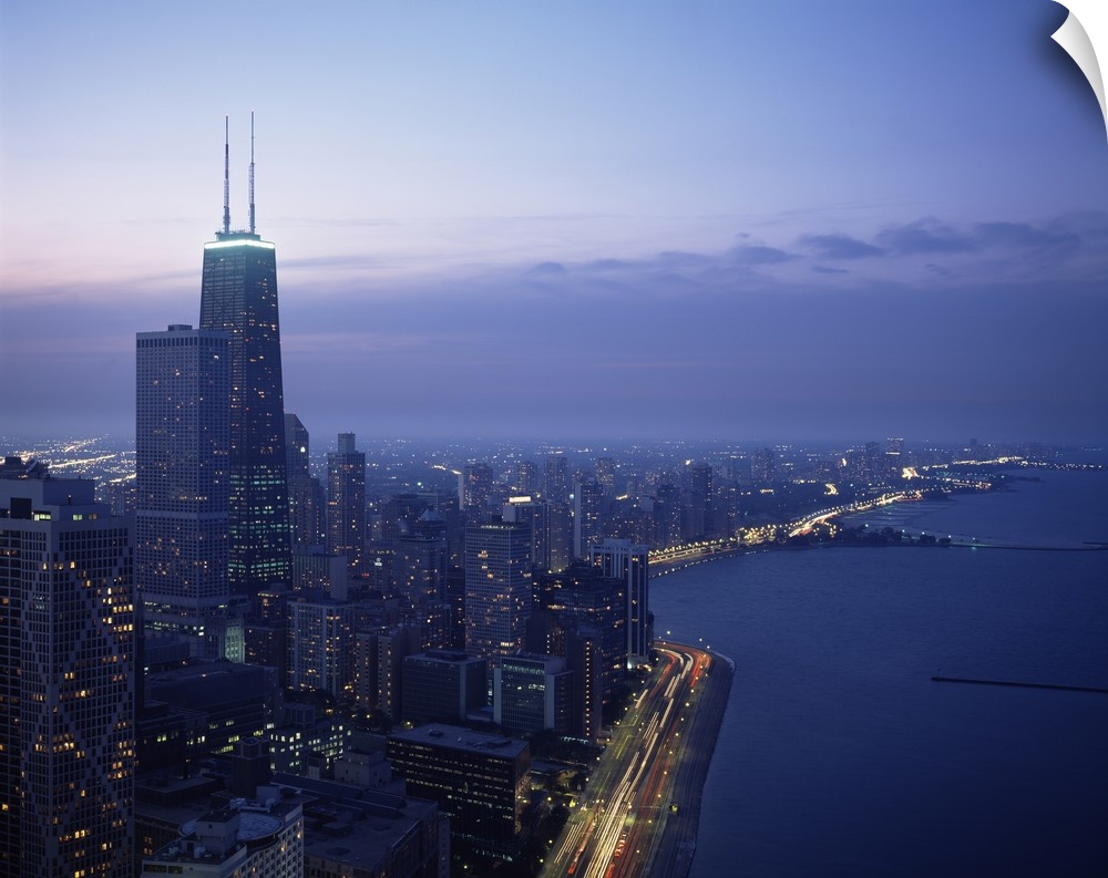 This large piece is a photograph taken of Chicago during dusk showing the busy city to the left and the lake to the right ...