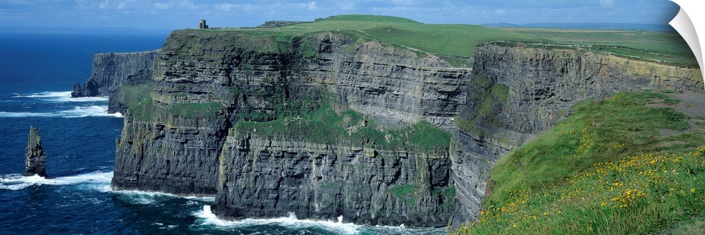 Panoramic photograph of the Cliffs of Moher County Clare in Ireland on a sunny day.