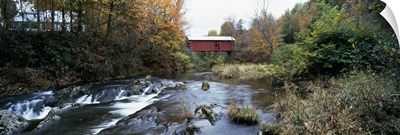 Covered bridge across a river, Northfield Falls, Vermont