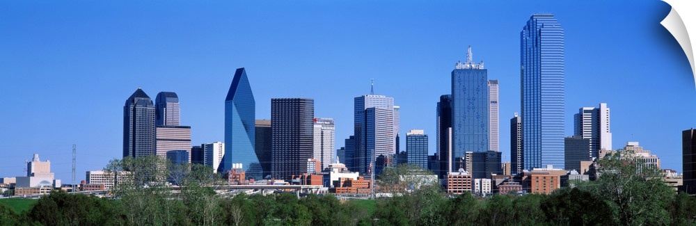 The city skyscrapers reflect the colors of the sky in this panoramic photograph taken on a sunny cloud free day.