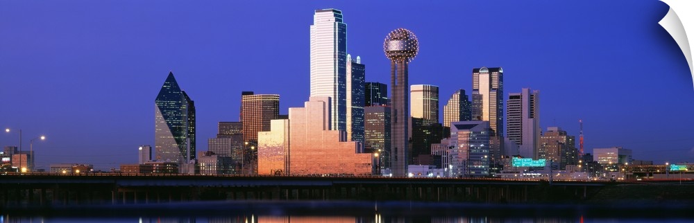 A large panoramic piece that is a photograph of the Dallas skyline at dusk.