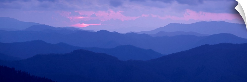 A panoramic photograph of the Appalachian Mountains under a pastel colored sky at sunrise.