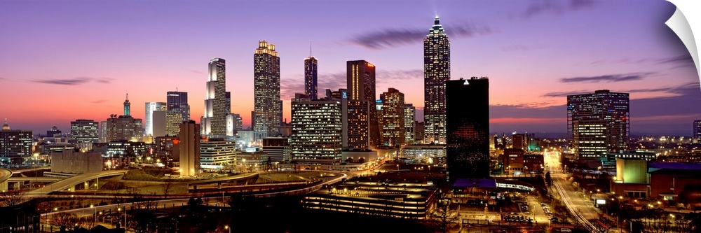 Panoramic photograph showcasing the busy city streets and large skyscrapers of Atlanta, Georgia taken at dusk.