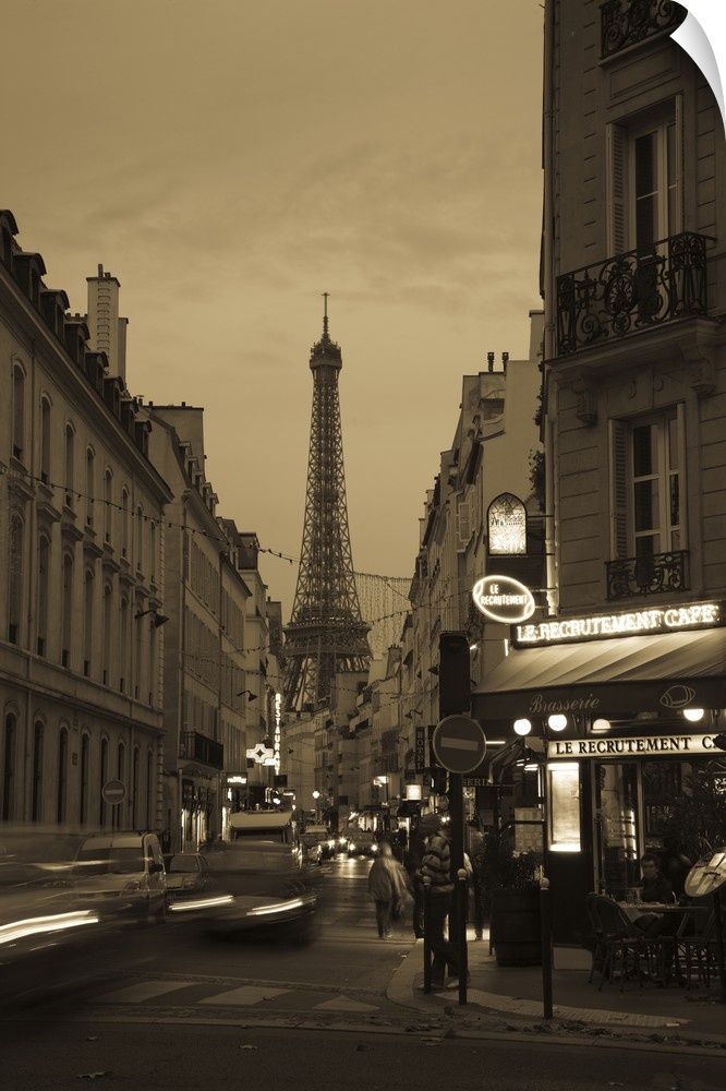 Vertical photo on canvas of a street with the Eiffel Tower in the background at dusk.