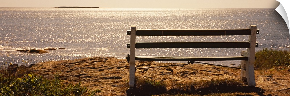 Panoramic photo on canvas of an empty bench overlooking a beach in the northeast US.