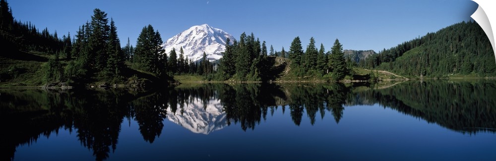 Panoramic photograph of Mount Rainier and surrounding green forest, reflecting in the still waters of Eunice Lake, in Moun...