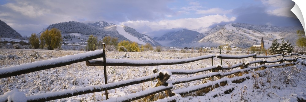 Fence on a snow covered landscape and a chapel in the background, Prince Of Peace Chapel, Aspen, Colorado