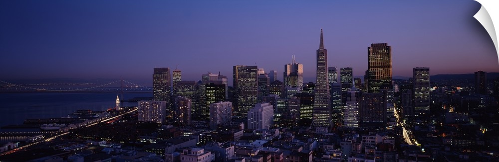 Aerial photograph taken of the San Francisco skyline illuminated under a night sky.