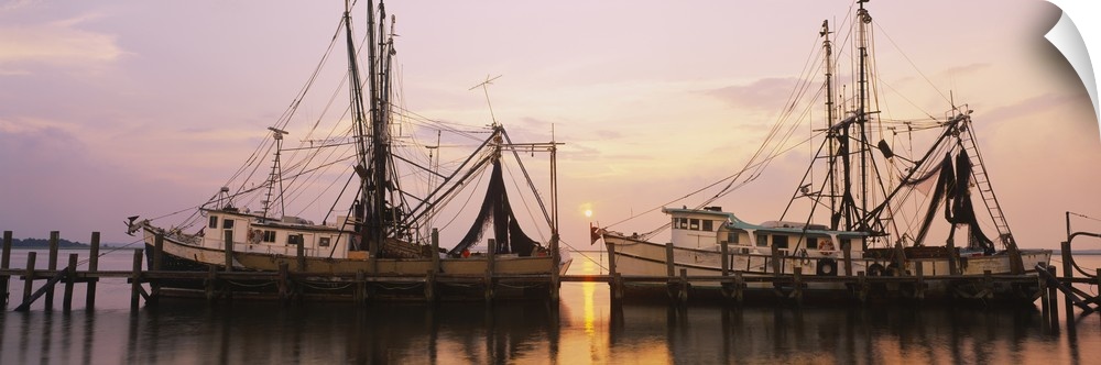 Wide angle photograph of two large fishing boats anchored alongside a dock in the Amelia River, at Fernandina Beach, Florida.