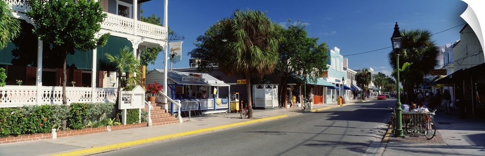 Panoramic photograph of street lined with shops in southern beach town.