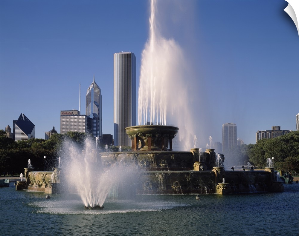 This massive fountain is photographed in front of skyscrapers in the city of Chicago.