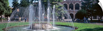 Fountain in Piazza Bra w/ Roman amphitheater Verona Italy