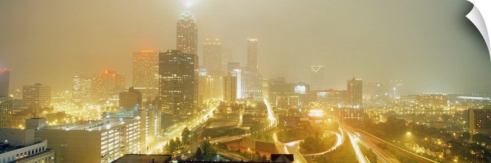 A time-lapsed photograph of the roads through the city and skyscrapers in the fog on a panoramic shaped decorative print.
