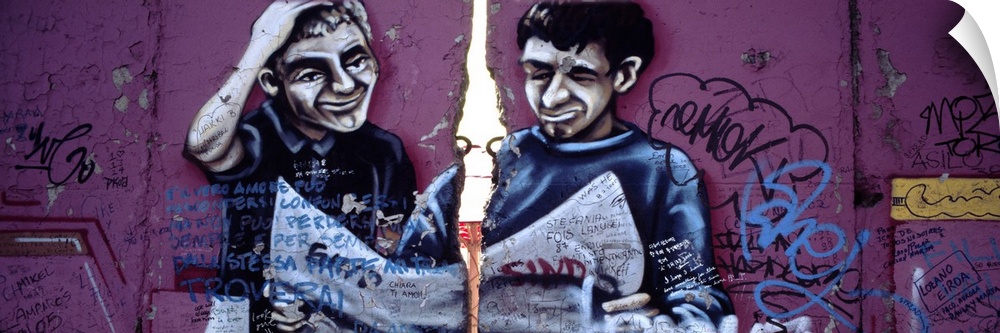 Panoramic photograph of street art depicting two men looking at a map on a huge wall.