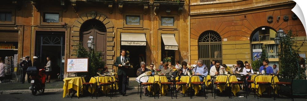 A panoramic view of diners sitting outside a restaurant in Italy.