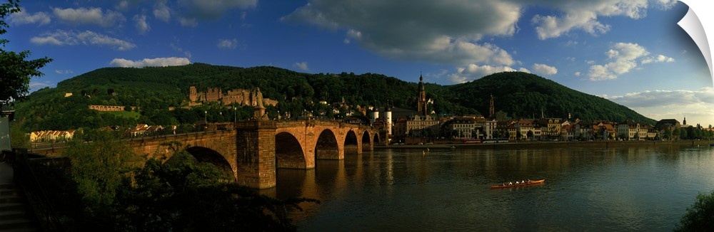Panoramic photo on canvas of an old stone bridge entering a German city along the waterfront.