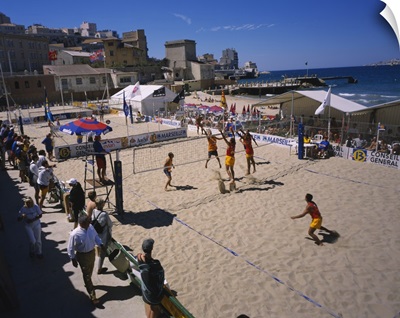 High angle view of a group of men playing volleyball on the beach, Plage des Catalans, Marseille, France