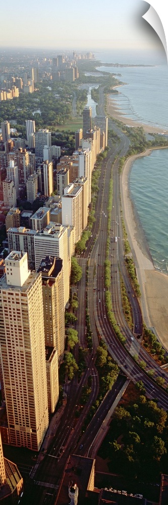 Arial vertical panoramic looking down at Lake Shore Drive in Chicago with the tall skyscrapers looking down at Lake Michigan.