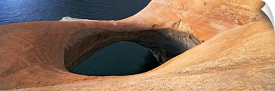 High angle view of a pothole arch at a lakeside, Lake Powell, Utah