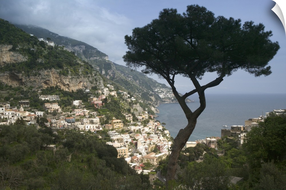 Photo taken high up in the cliffs of the Amalfi Coast looking down at the light colored buildings of the town that overloo...