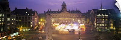 High angle view of a town square lit up at dusk, Dam Square, Amsterdam, Netherlands
