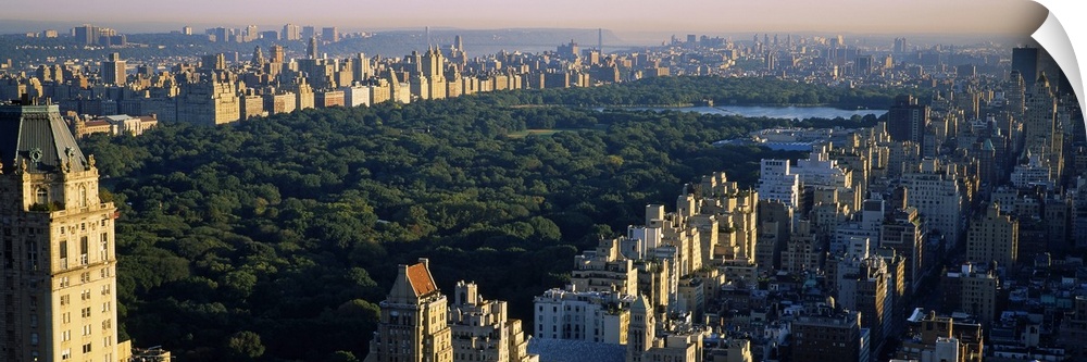 Panoramic canvas photo of the trees and lake in Central Park surrounded by the buildings of the city.