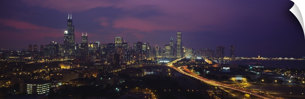 Panoramic photograph from above of the lights of the Chicago city skyline at night.