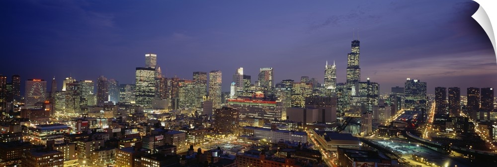 Panoramic photograph taken of downtown Chicago during the night with all the building windows illuminated.