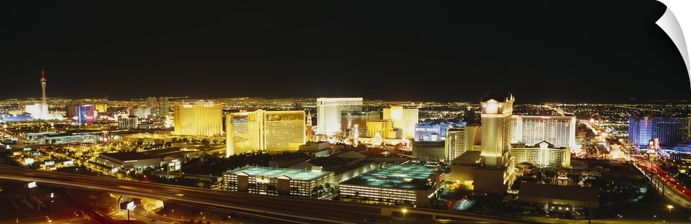Panoramic, high angle photograph of brightly lit buildings of the Las Vegas skyline, in Nevada.