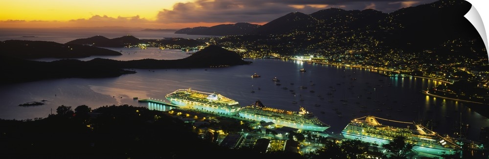 Wide angle, aerial photograph of several cruise ships, lit at night, along the shore of Charlotte Amalie, St. Thomas, US V...