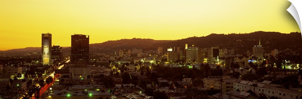 Oversized, high angle photograph of the Hollywood Hills, lit up at sunset, in Hollywood California.