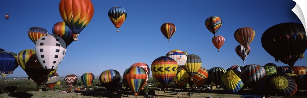 Panoramic photo of dozens of colorful hot air balloons taking flight at the International Balloon Fiesta in Albuquerque, N...