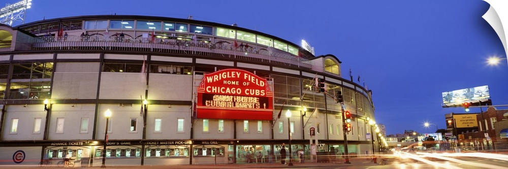 Panoramic photograph displays a nighttime view of the famous marquee sitting outside Wrigley Field, the home of a Major Le...