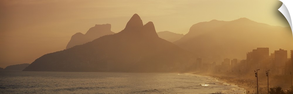 Giant landscape photograph of silhouetted mountains near the coast of Ipanema Beach in Rio de Janeiro, Brazil.
