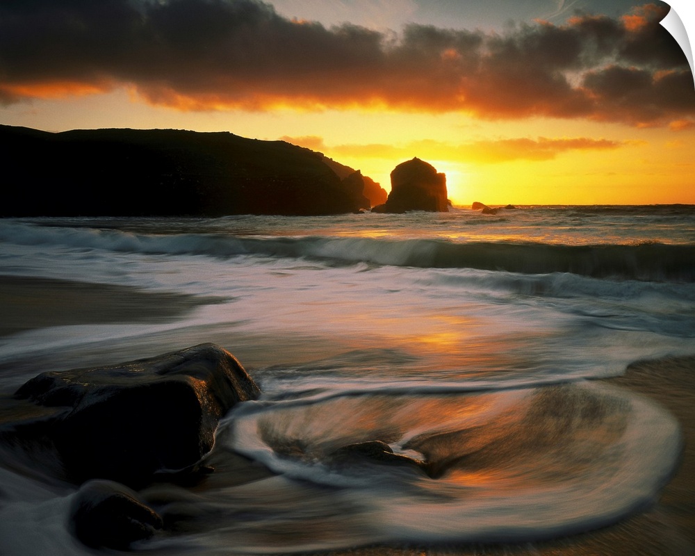 Beautiful time lapsed photography wall art of waves on the beach at sunset.