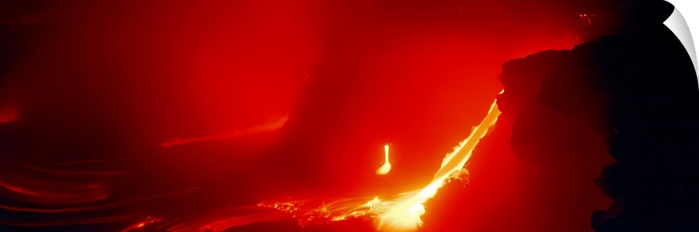 Glowing panoramic photograph of lava flowing from domed mountain.